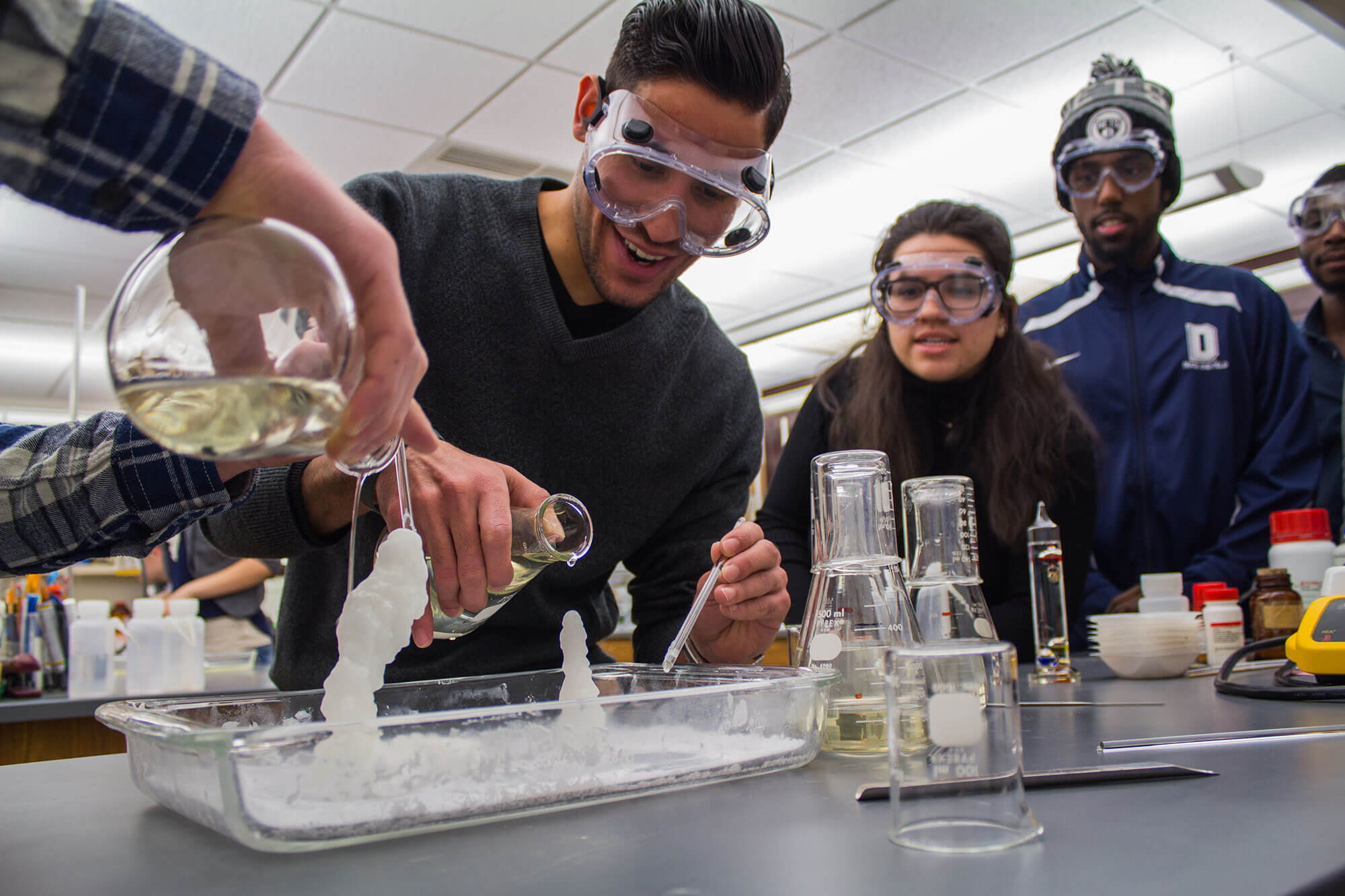 Group of students conducting experiments in a chemistry lab.